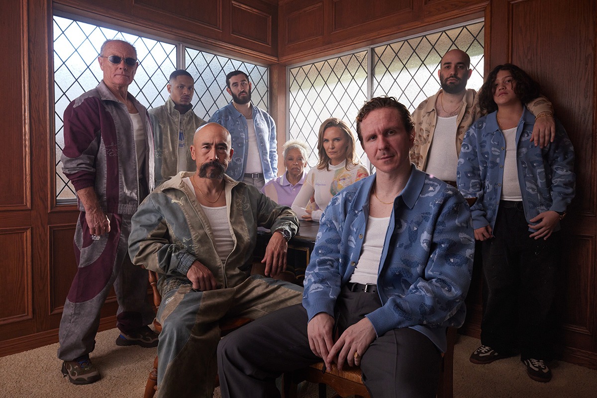 Group portrait in the collaboration track jackets, trousers and knit cardigans