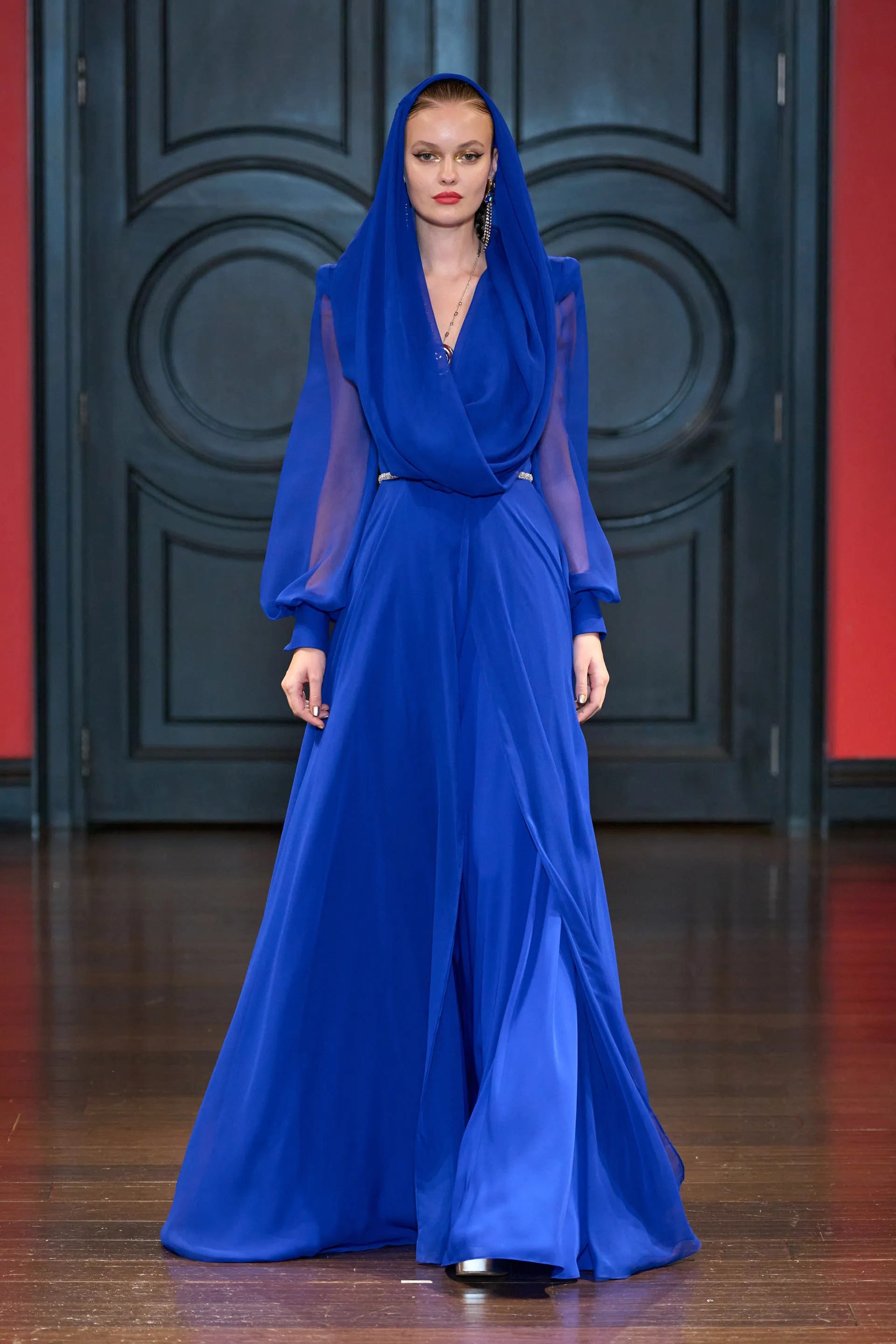 Model in the blue hooded chiffon gown